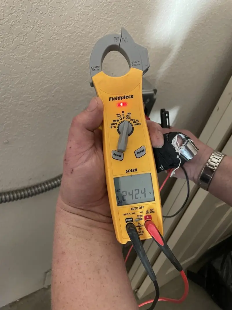 Voltage testing with clamp meter during Recessed Lighting Installation in Glocester